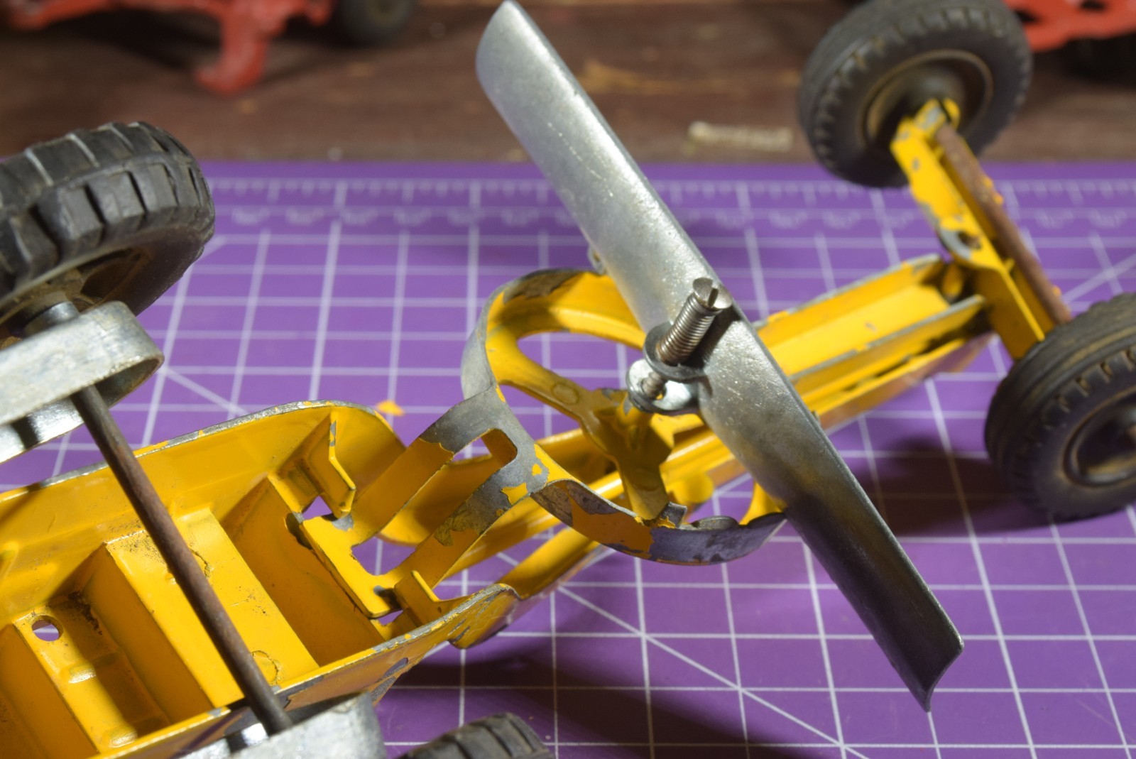 Hubley yellow grader, blade moves but re-engineered at swivel point has issues