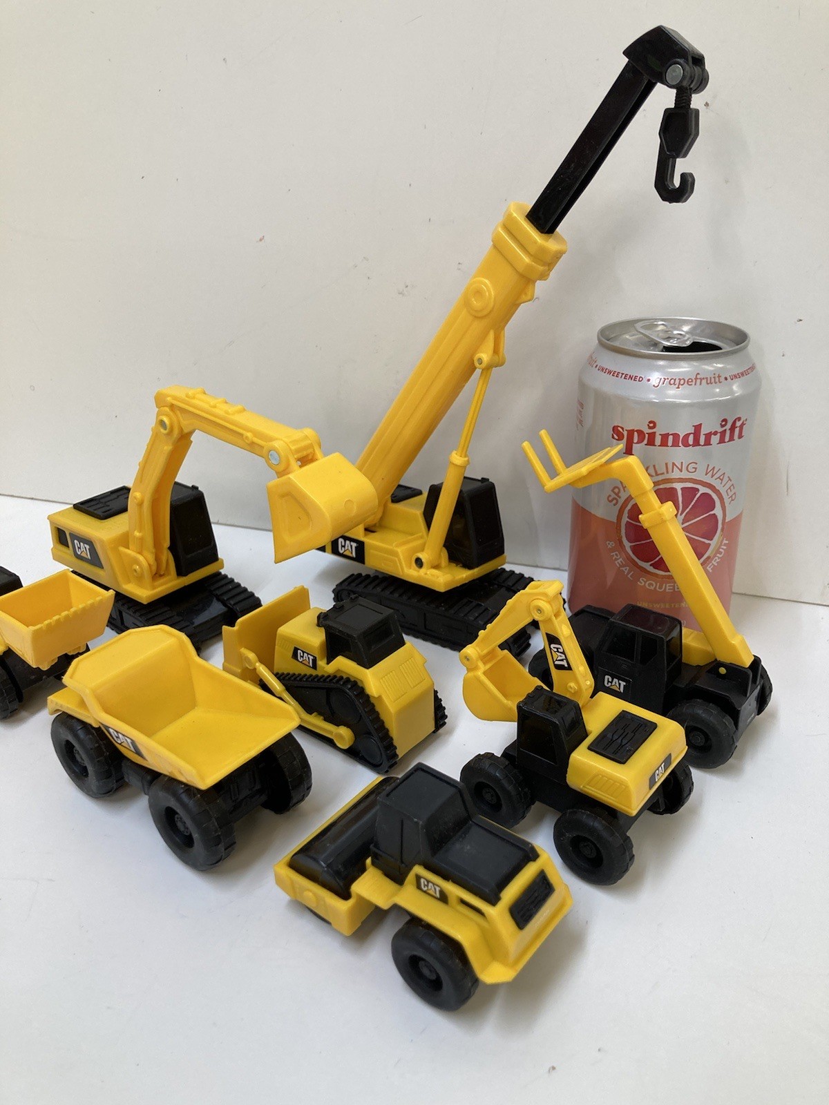 8 Small 3”-4” Long Plastic Toy Caterpillar Construction Trucks. Movable Parts