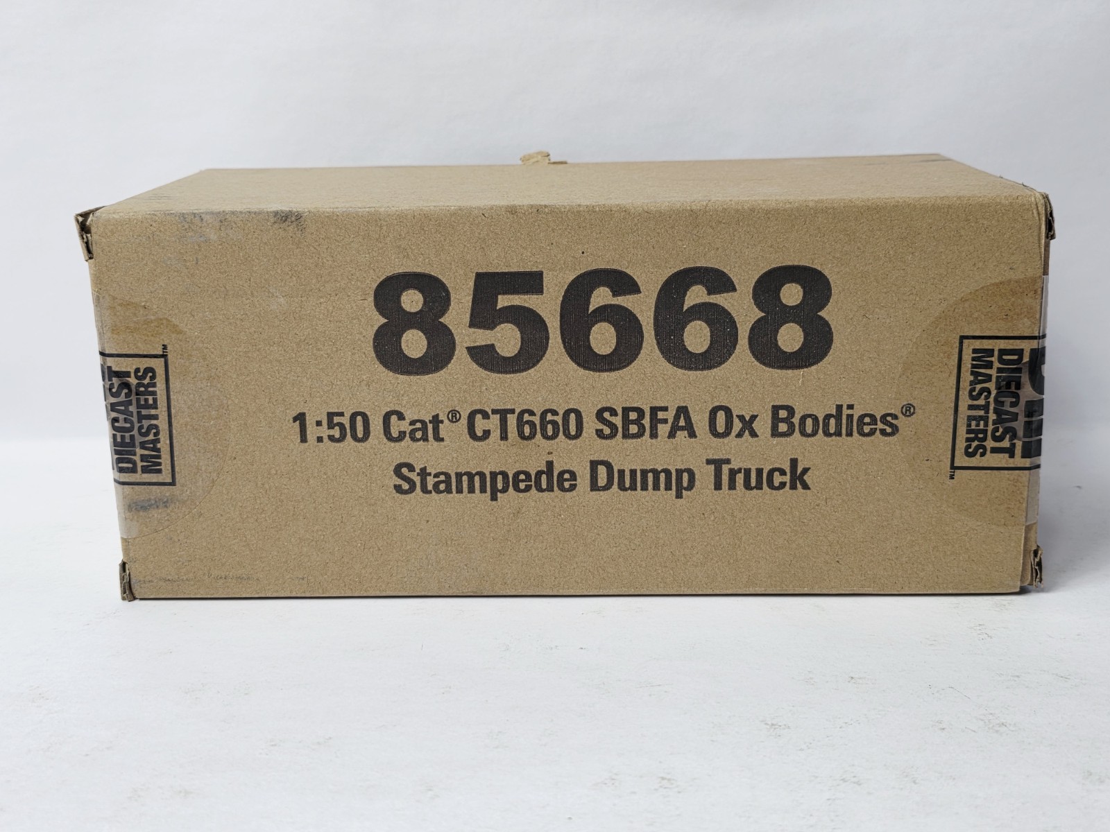 DIECAST MASTERS 85668 CAT SBFA OX BODY STAMPEDE DUMP TRUCK NEW IN BOX VERY NICE!